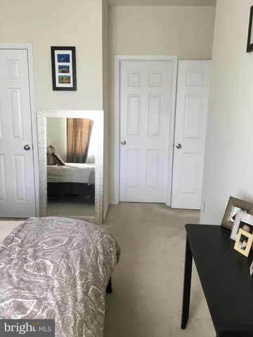 a bedroom with a bed and couch