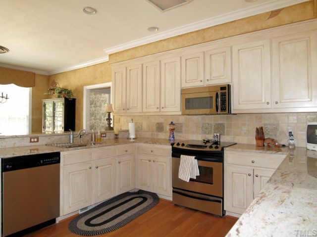 9117 Storrington Way Raleigh, NC 27615 - Photo 6 of 12 Upgraded and Remodeled kichen w/ Granite and tile back splash.