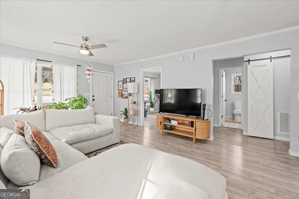 a living room with furniture and a flat screen tv