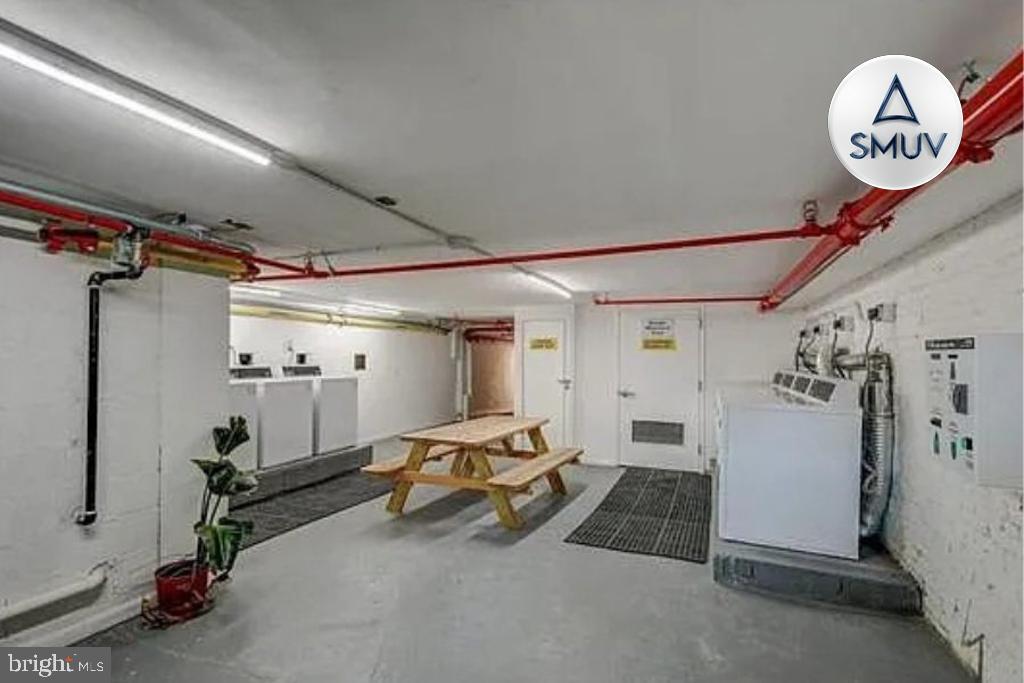 231 East North Avenue, Unit 222 Baltimore, MD 21202 - Photo 3 of 20 Functional communal laundry space with seating.