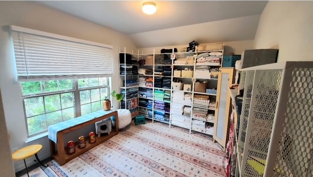 3833 Mercer Road Georgetown, TX 78628 - Photo 13 of 25 A window-filled corner offers organizational shelving and a vibrant floor covering.