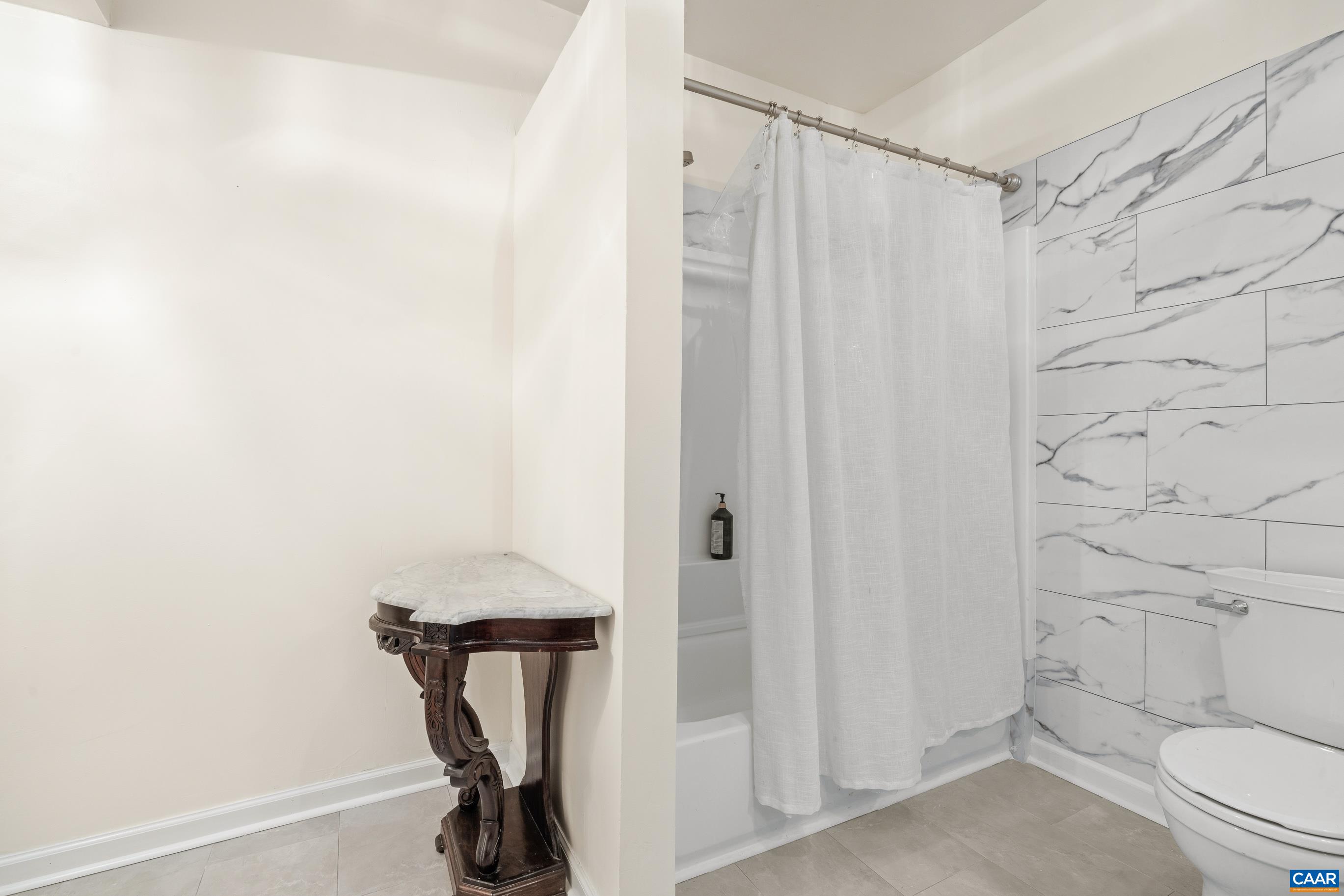 1236 Amber Ridge Road Charlottesville, VA 22901 - Photo 34 of 56 a bathroom with a shower curtain