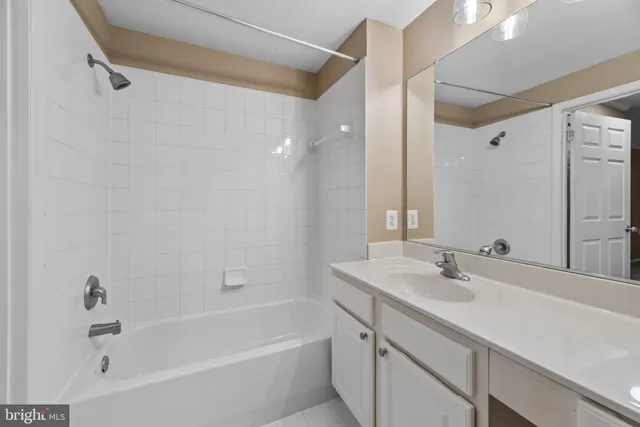 a bathroom with a tub sink and mirror