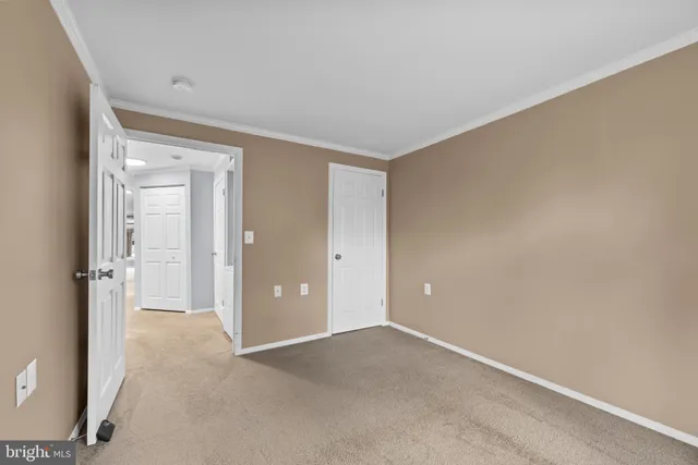a view of an empty room and closet area