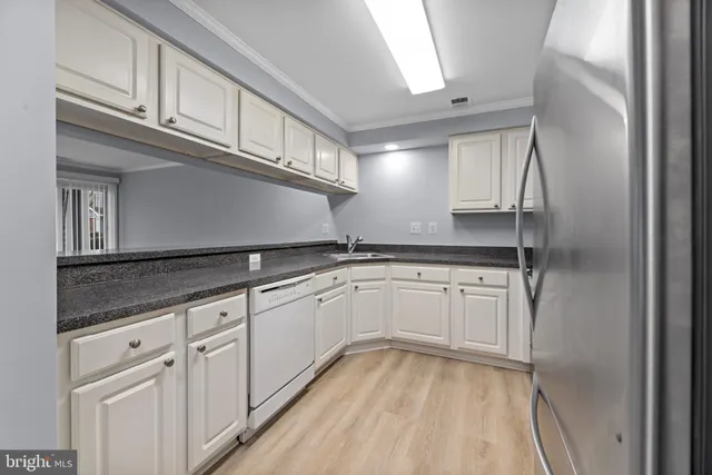 a kitchen with granite countertop cabinets stainless steel appliances and a counter space