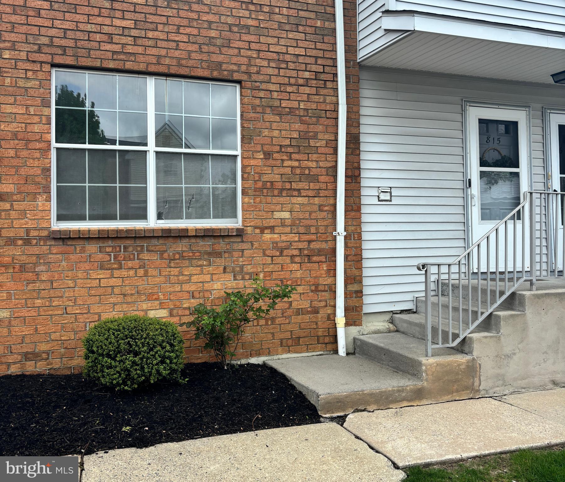 a view of a brick house with large windows