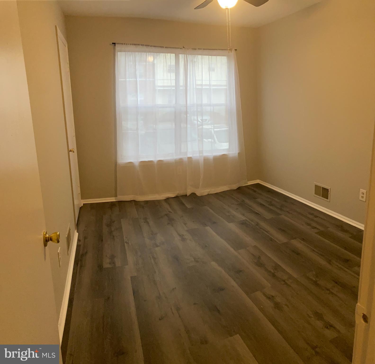815 Woodchip Road Lumberton, NJ 08048 - Photo 10 of 11 an empty room with wooden floor and windows