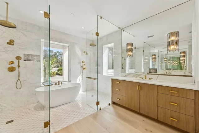 a spacious bathroom with a double vanity sink a large mirror and a bathtub