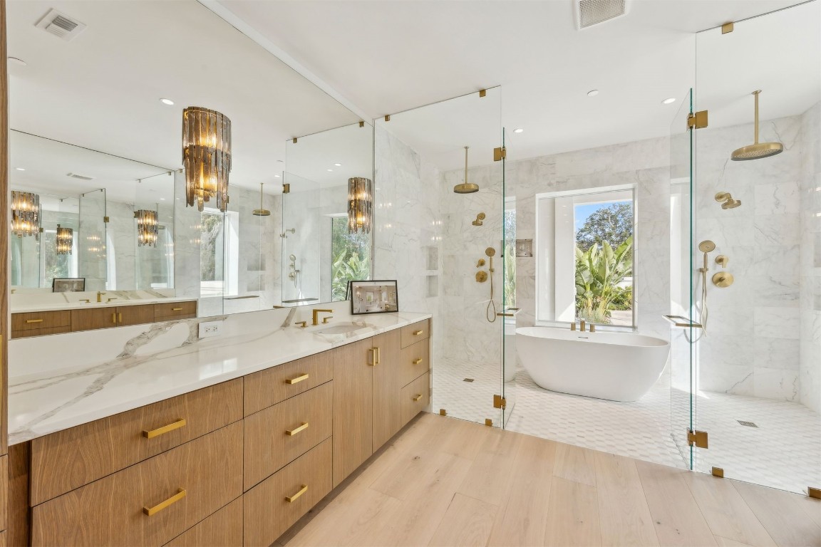 5063 1st Coast Highway, Unit 101D Fernandina Beach, FL 32034 - Photo 21 of 58 a spacious bathroom with a granite countertop sink mirror and a bathtub