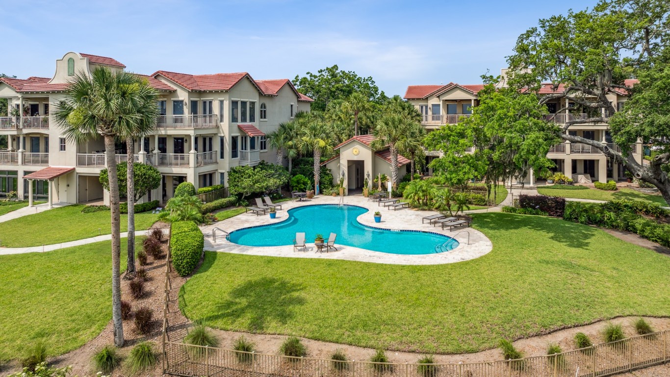 5063 1st Coast Highway, Unit 101D Fernandina Beach, FL 32034 - Photo 26 of 58 a view of a house with swimming pool and yard
