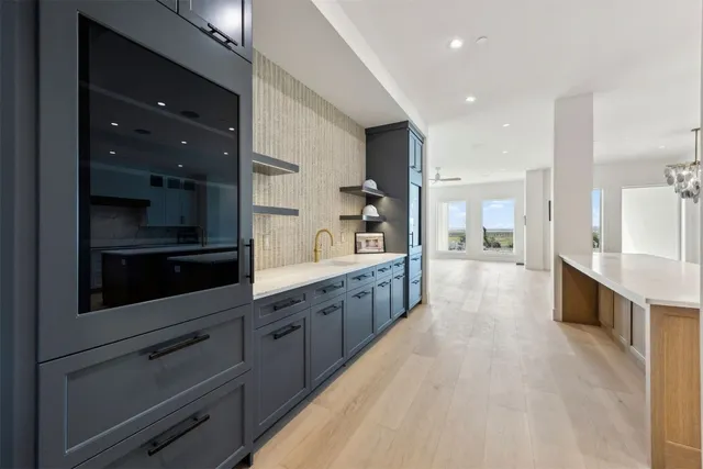 a large kitchen with stainless steel appliances kitchen island granite countertop a large counter top and stainless steel appliances