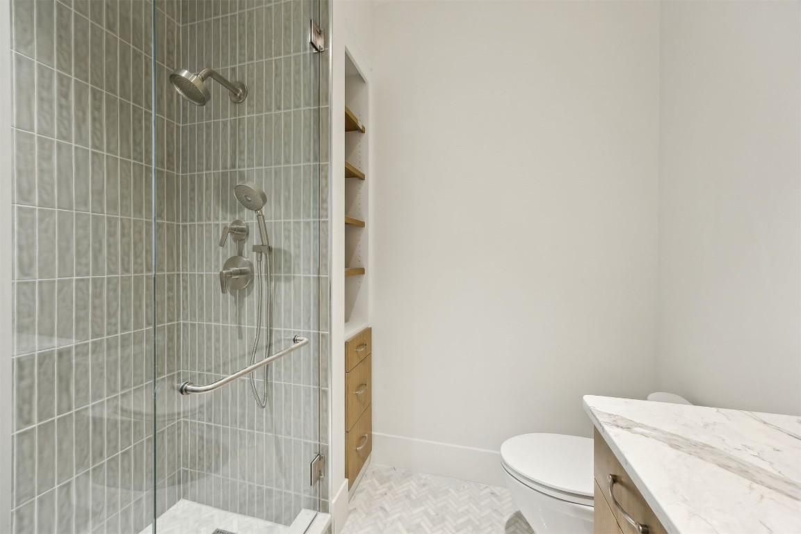 5063 1st Coast Highway, Unit 101D Fernandina Beach, FL 32034 - Photo 35 of 58 a bathroom with a toilet and shower