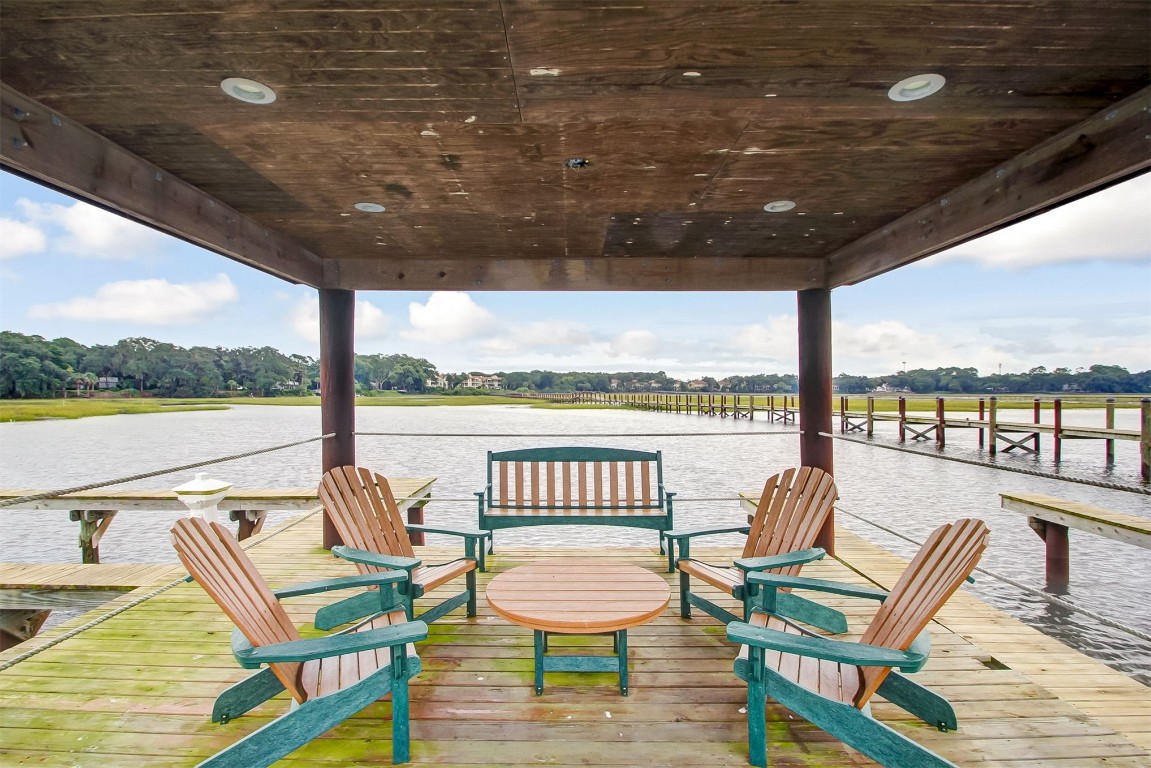 5063 1st Coast Highway, Unit 101D Fernandina Beach, FL 32034 - Photo 53 of 58 a view of a chairs and table in wooden deck