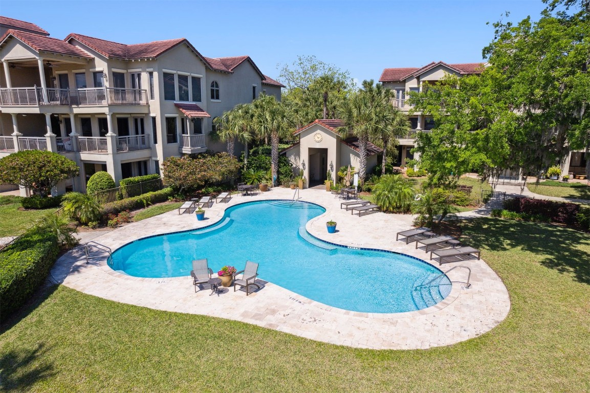 5063 1st Coast Highway, Unit 101D Fernandina Beach, FL 32034 - Photo 55 of 58 a view of a swimming pool with a yard