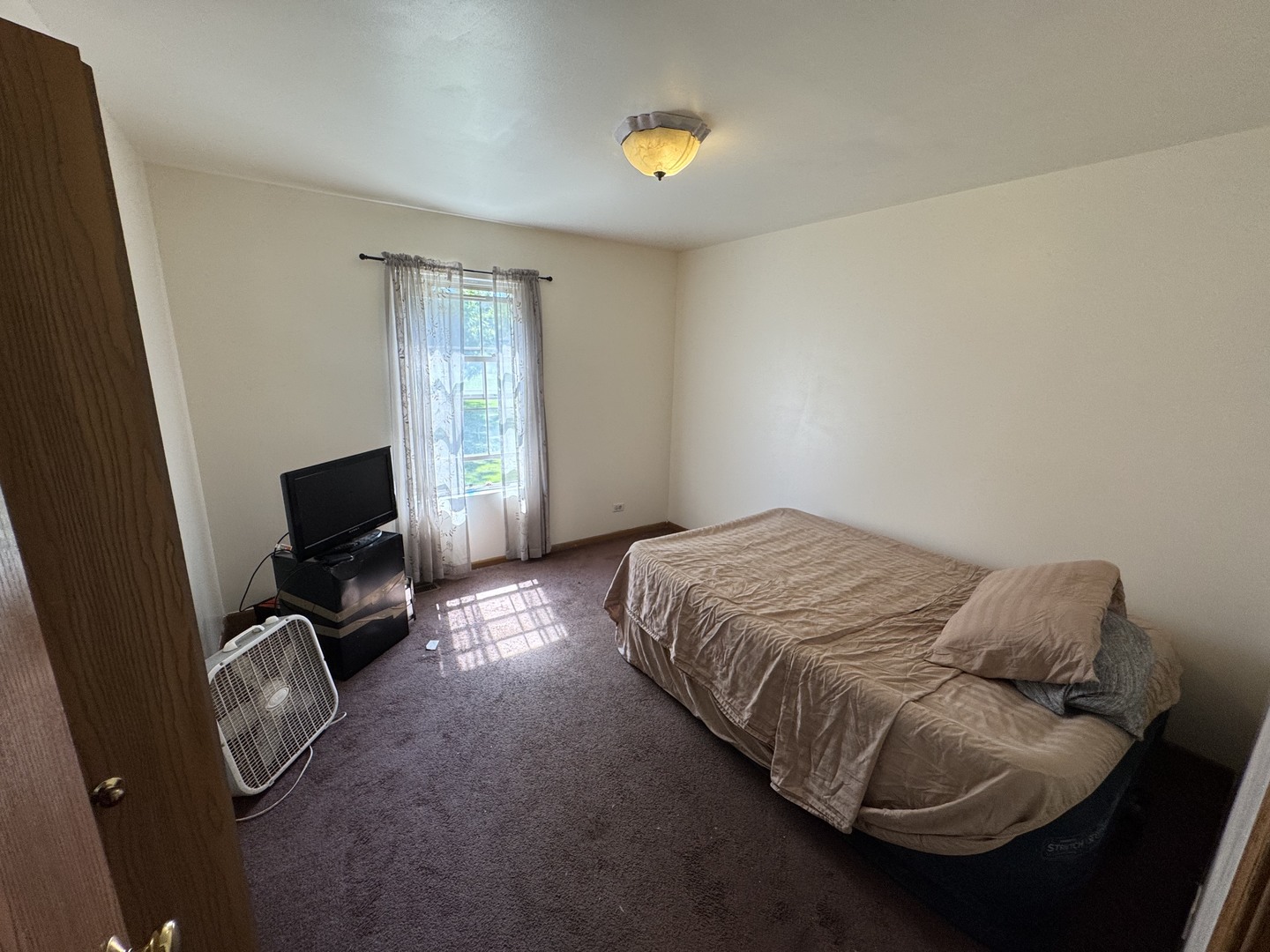 3831 West 154th Street Markham, IL 60428 - Photo 12 of 24 a bedroom with a bed couch and a window