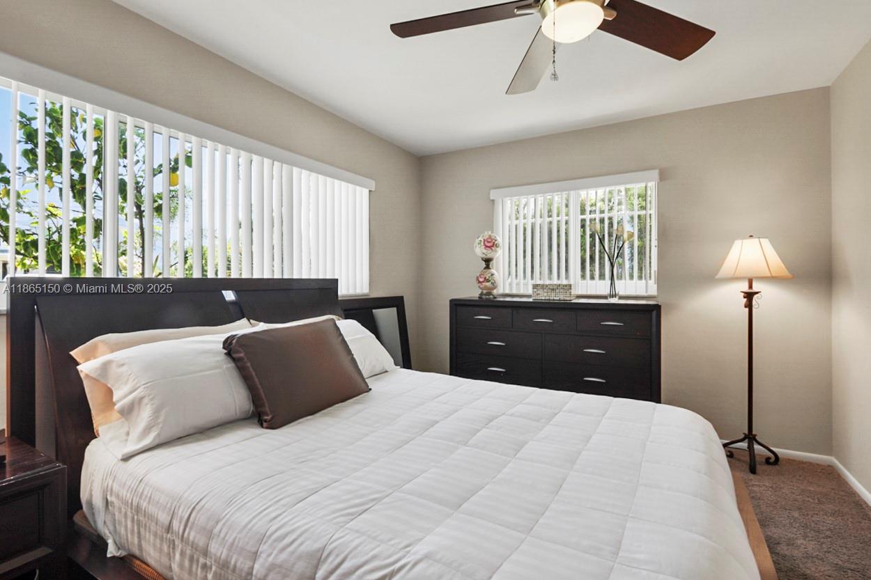 19125 Waterway Road Jupiter, FL 33469 - Photo 12 of 33 a bedroom with a bed and a lamp