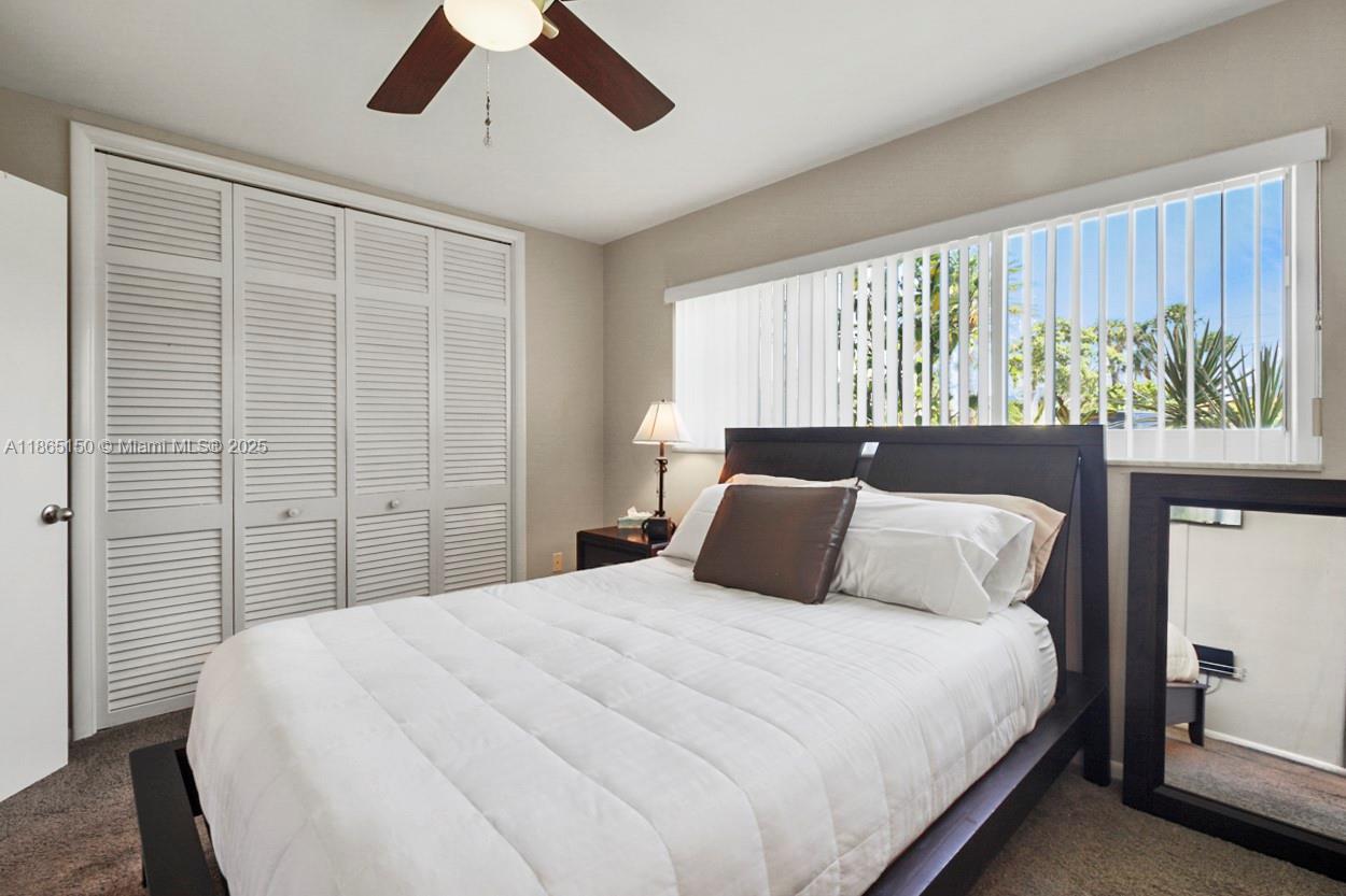 19125 Waterway Road Jupiter, FL 33469 - Photo 13 of 33 a bedroom with a large bed and a window