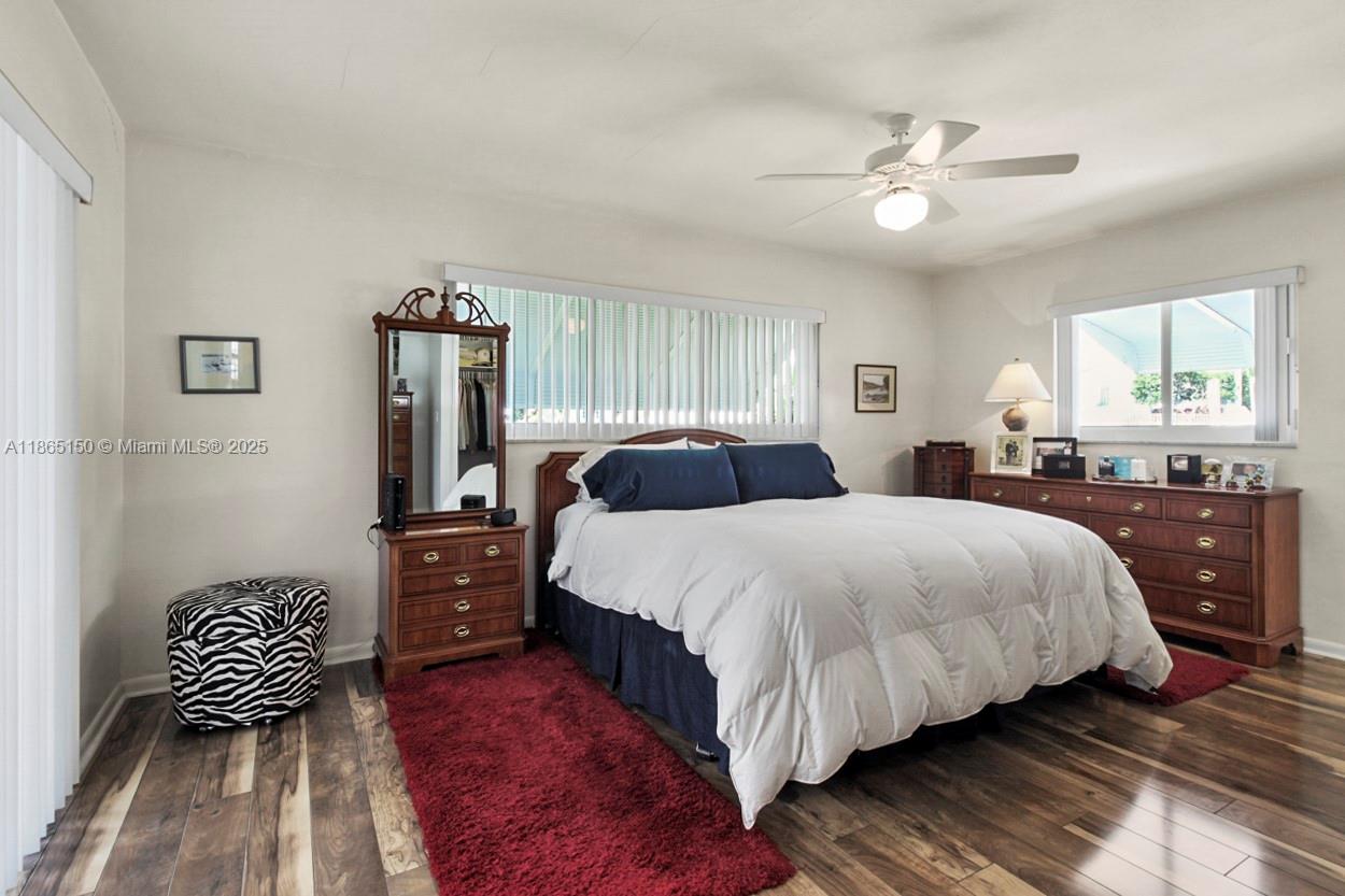 19125 Waterway Road Jupiter, FL 33469 - Photo 14 of 33 a bedroom with a bed and a chandelier