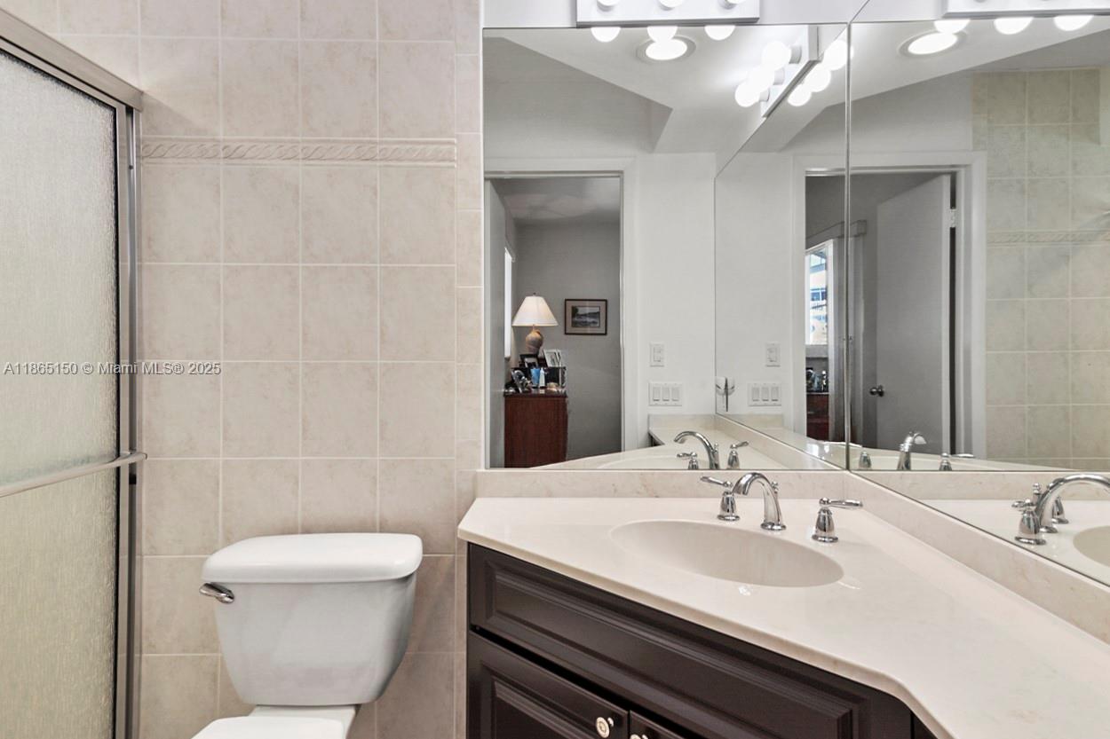 19125 Waterway Road Jupiter, FL 33469 - Photo 16 of 33 a bathroom with a sink a toilet and shower