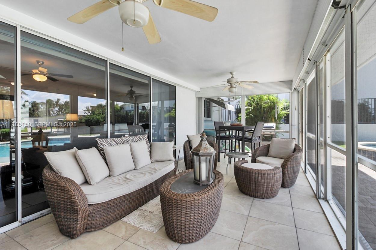 19125 Waterway Road Jupiter, FL 33469 - Photo 20 of 33 a living room with furniture potted plant and a large window