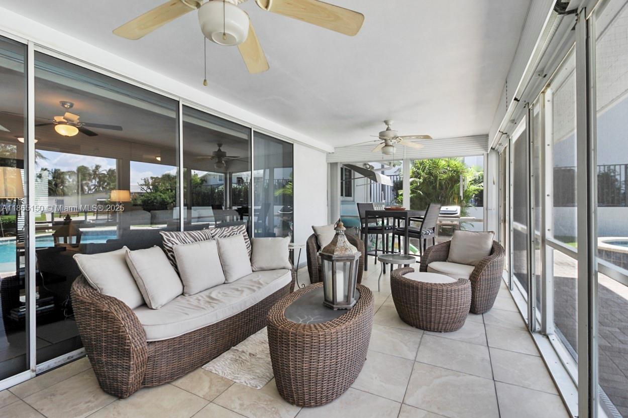 19125 Waterway Road Jupiter, FL 33469 - Photo 20 of 33 a living room with furniture potted plant and a large window