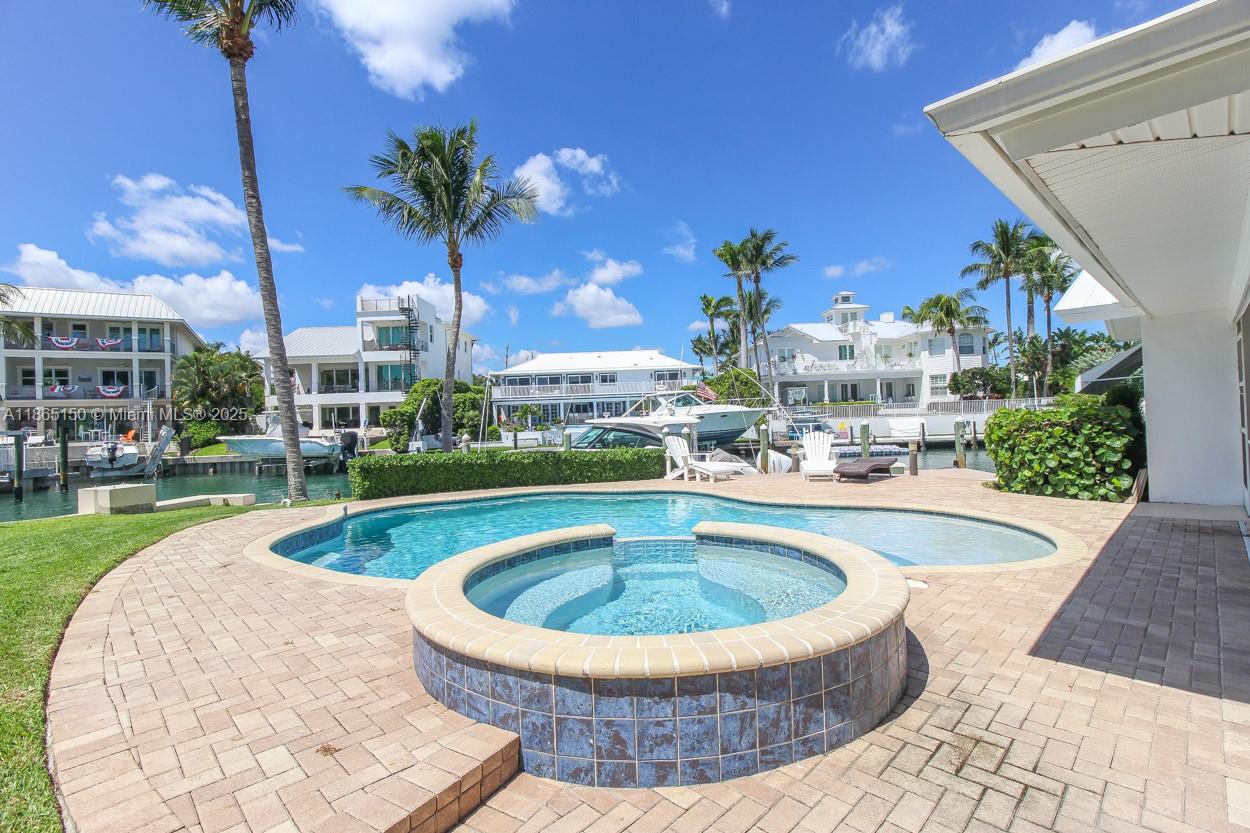 19125 Waterway Road Jupiter, FL 33469 - Photo 21 of 33 a view of a swimming pool with a garden