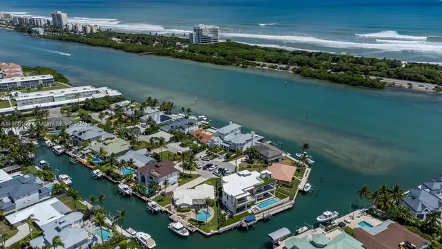 an aerial view of a house with outdoor space and a lake view