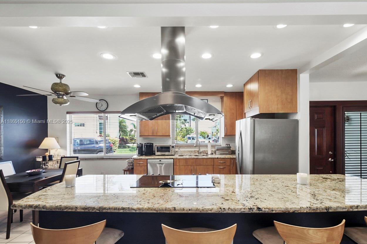19125 Waterway Road Jupiter, FL 33469 - Photo 3 of 33 a kitchen with granite countertop kitchen island stainless steel appliances a sink stove and refrigerator