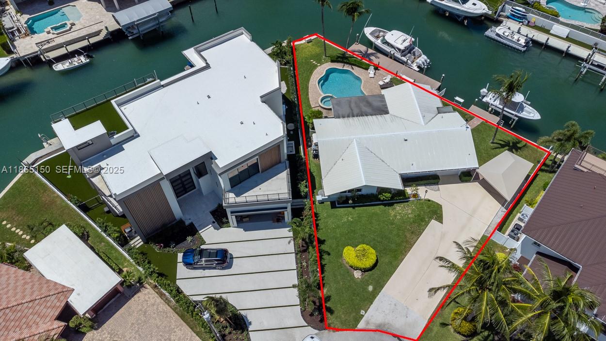 19125 Waterway Road Jupiter, FL 33469 - Photo 31 of 33 an aerial view of a house with a garden and a lake view
