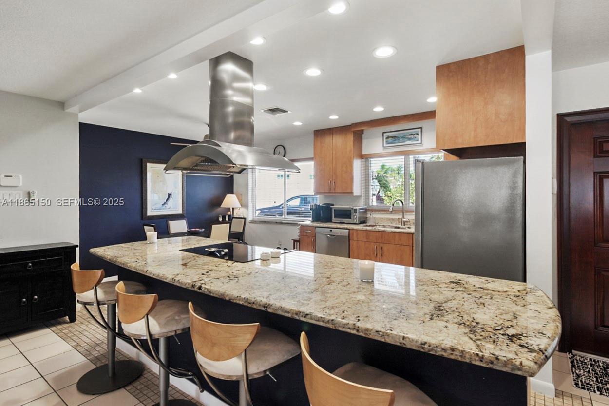 19125 Waterway Road Jupiter, FL 33469 - Photo 4 of 33 a kitchen with granite countertop kitchen island stainless steel appliances a sink stove and refrigerator