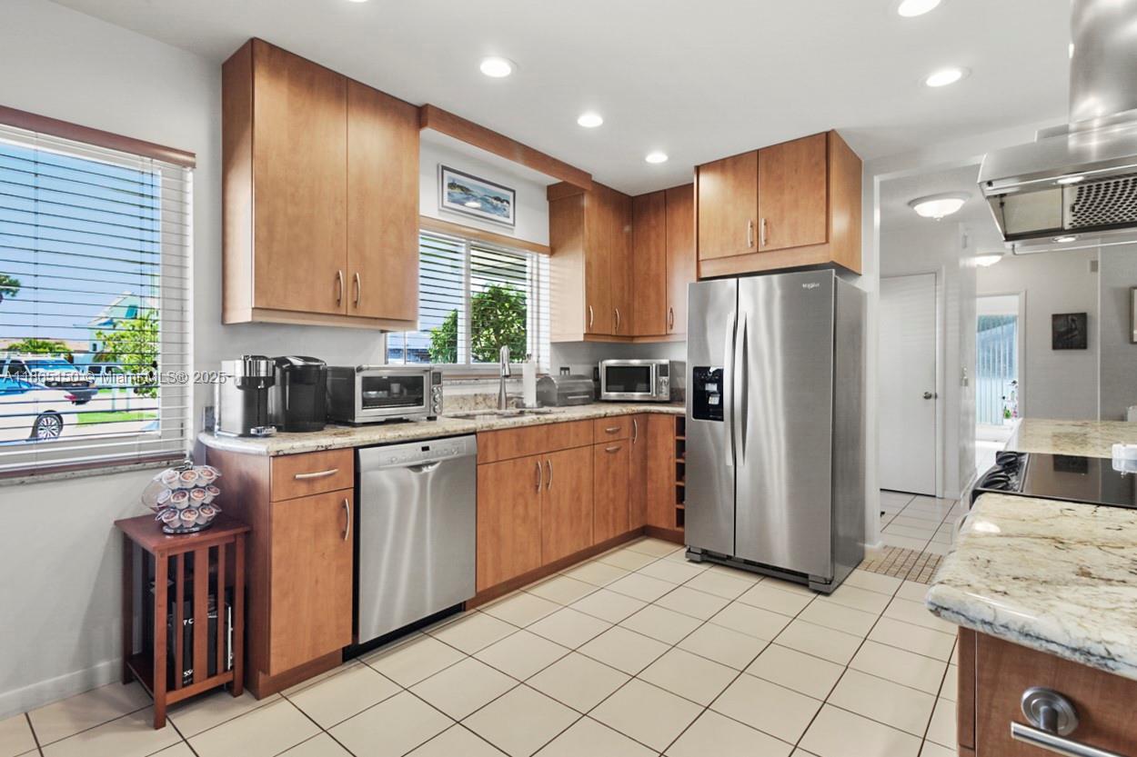 19125 Waterway Road Jupiter, FL 33469 - Photo 6 of 33 a kitchen with a refrigerator sink and cabinets