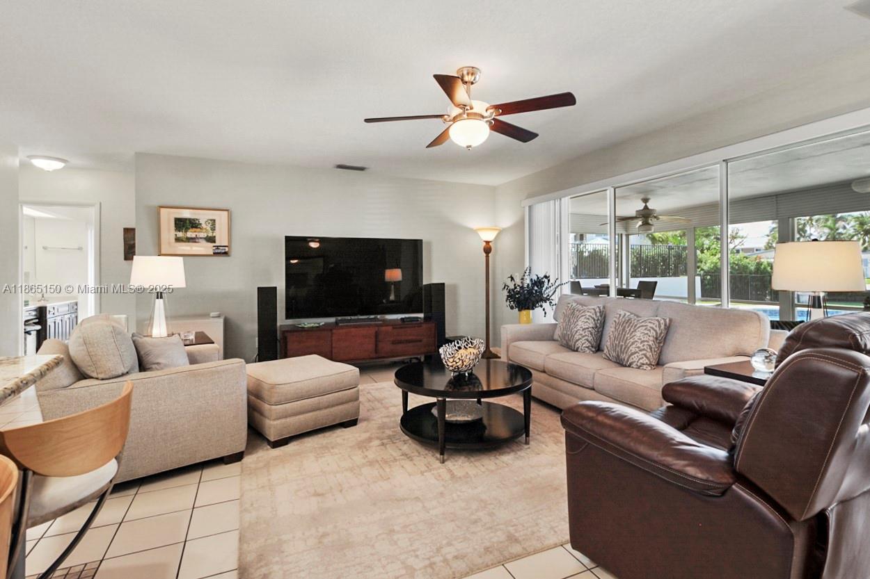 19125 Waterway Road Jupiter, FL 33469 - Photo 7 of 33 a living room with furniture a ceiling fan and a window