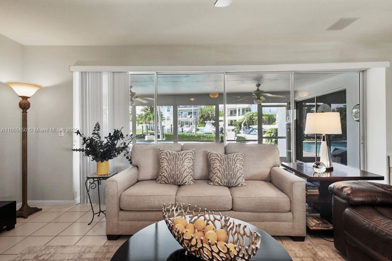 19125 Waterway Road Jupiter, FL 33469 - Photo 8 of 33 a living room with furniture and a large window
