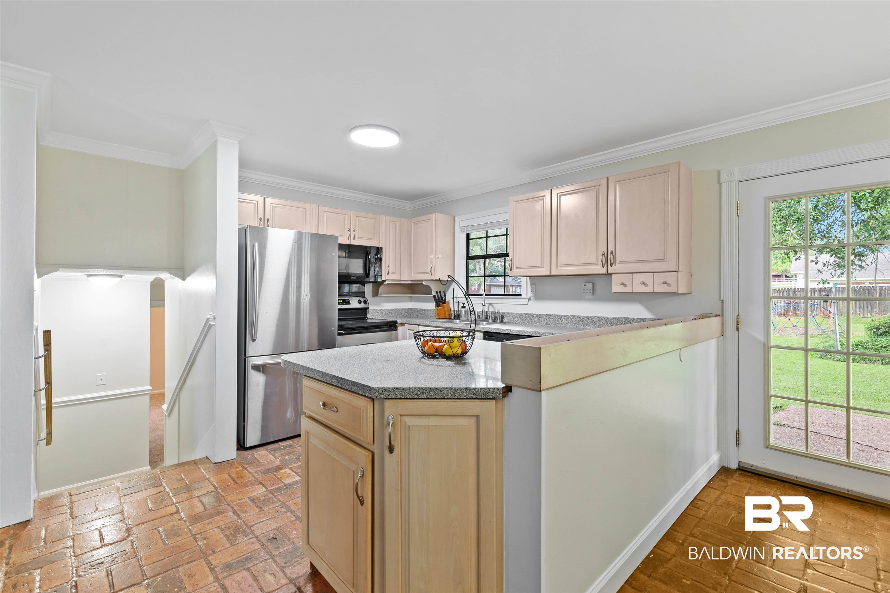 10420 Johnson Road South Mobile, AL 36695 - Photo 19 of 75 Kitchen area featuring brick-patterned flooring, light wood cabinetry with brushed nickel hardware, and stainless steel appliances