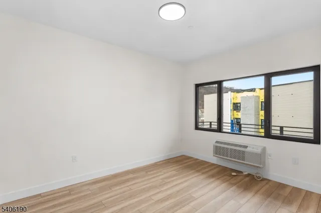 a view of a room with wooden floor and windows