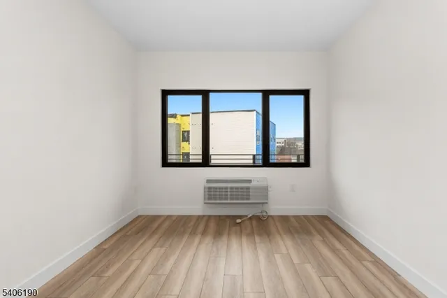 a view of wooden floor and windows in a room