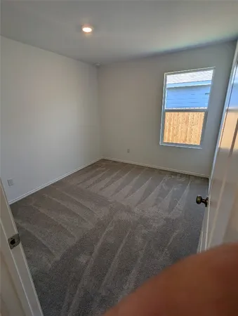 a view of an empty room and a window