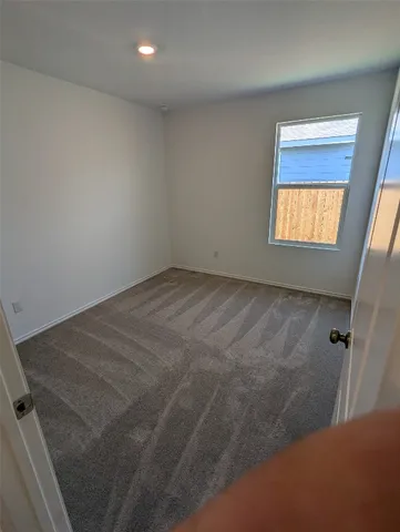 a view of an empty room and a window