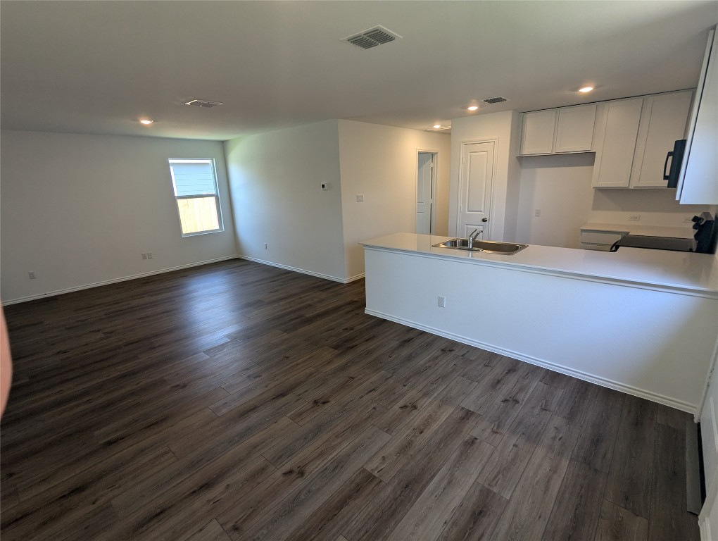 583 Commander Abbott Drive Jarrell, TX 76537 - Photo 5 of 24 an empty room with wooden floor and a window