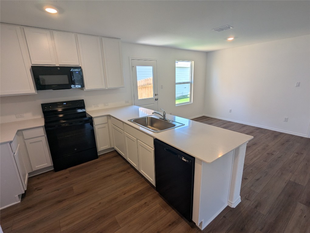 583 Commander Abbott Drive Jarrell, TX 76537 - Photo 6 of 24 a kitchen with a sink stove and microwave
