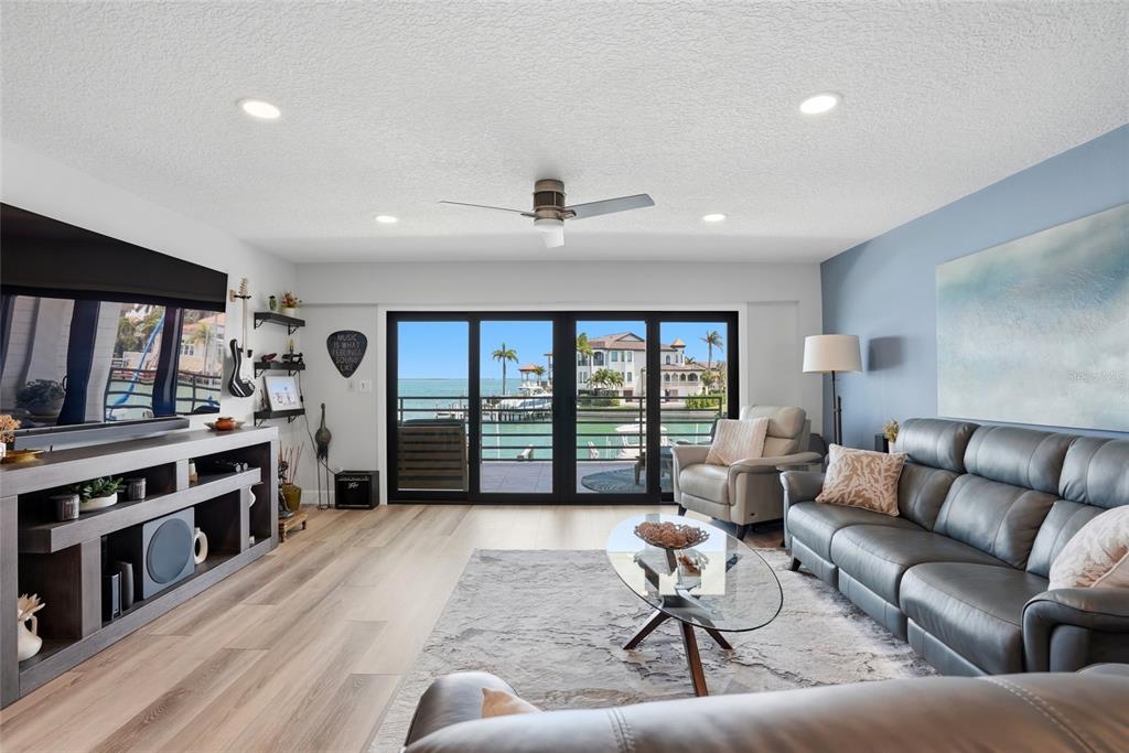 363 Pinellas Bayway South, Unit 29 Tierra Verde, FL 33715 - Photo 10 of 59 a living room with furniture and a flat screen tv