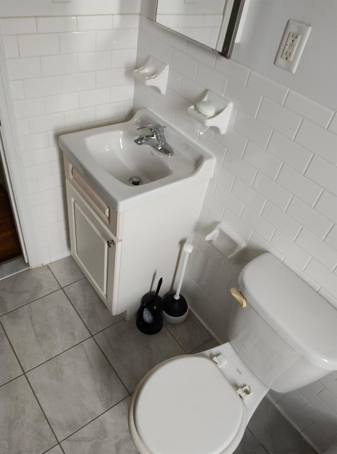 1015 Summit Avenue, Unit 6B Bronx, NY 10452 - Photo 12 of 21 a bathroom with a sink toilet and a mirror