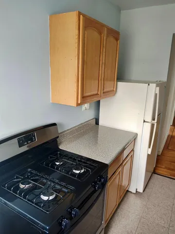 a stove top oven sitting inside of a kitchen