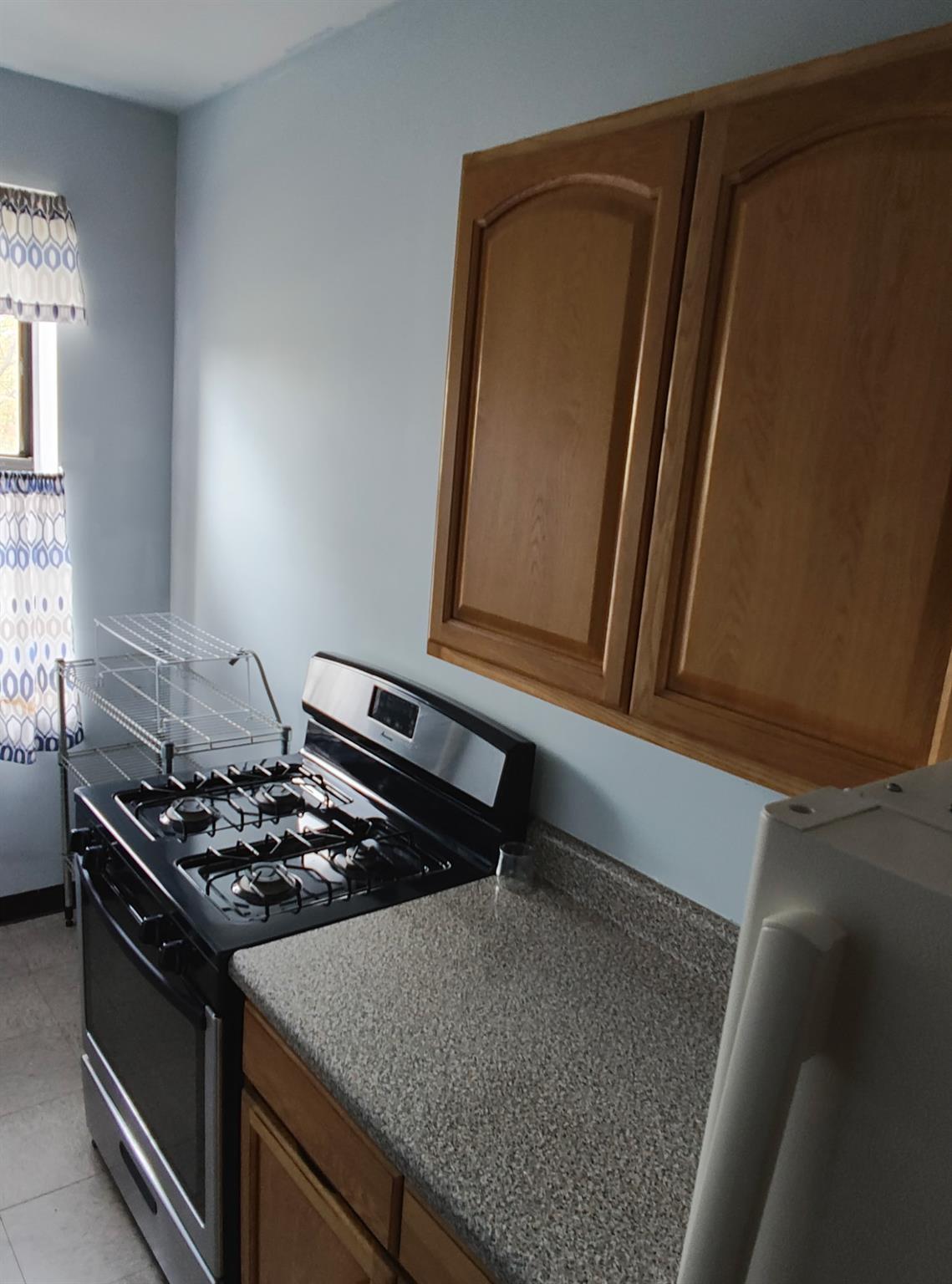 1015 Summit Avenue, Unit 6B Bronx, NY 10452 - Photo 9 of 21 a kitchen with a stove and a microwave