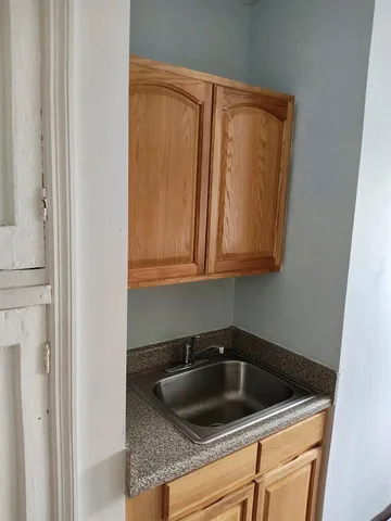 a kitchen with a sink and cabinets