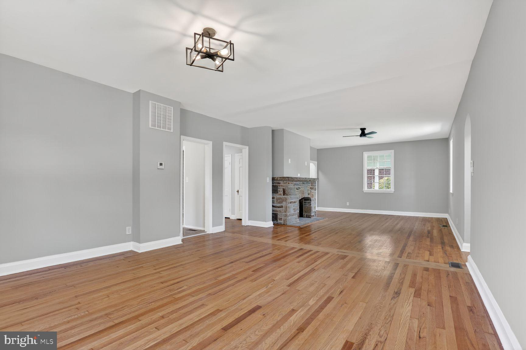 315 East Cold Spring Lane Baltimore, MD 21212 - Photo 22 of 25 a view of empty room with wooden floor and fireplace