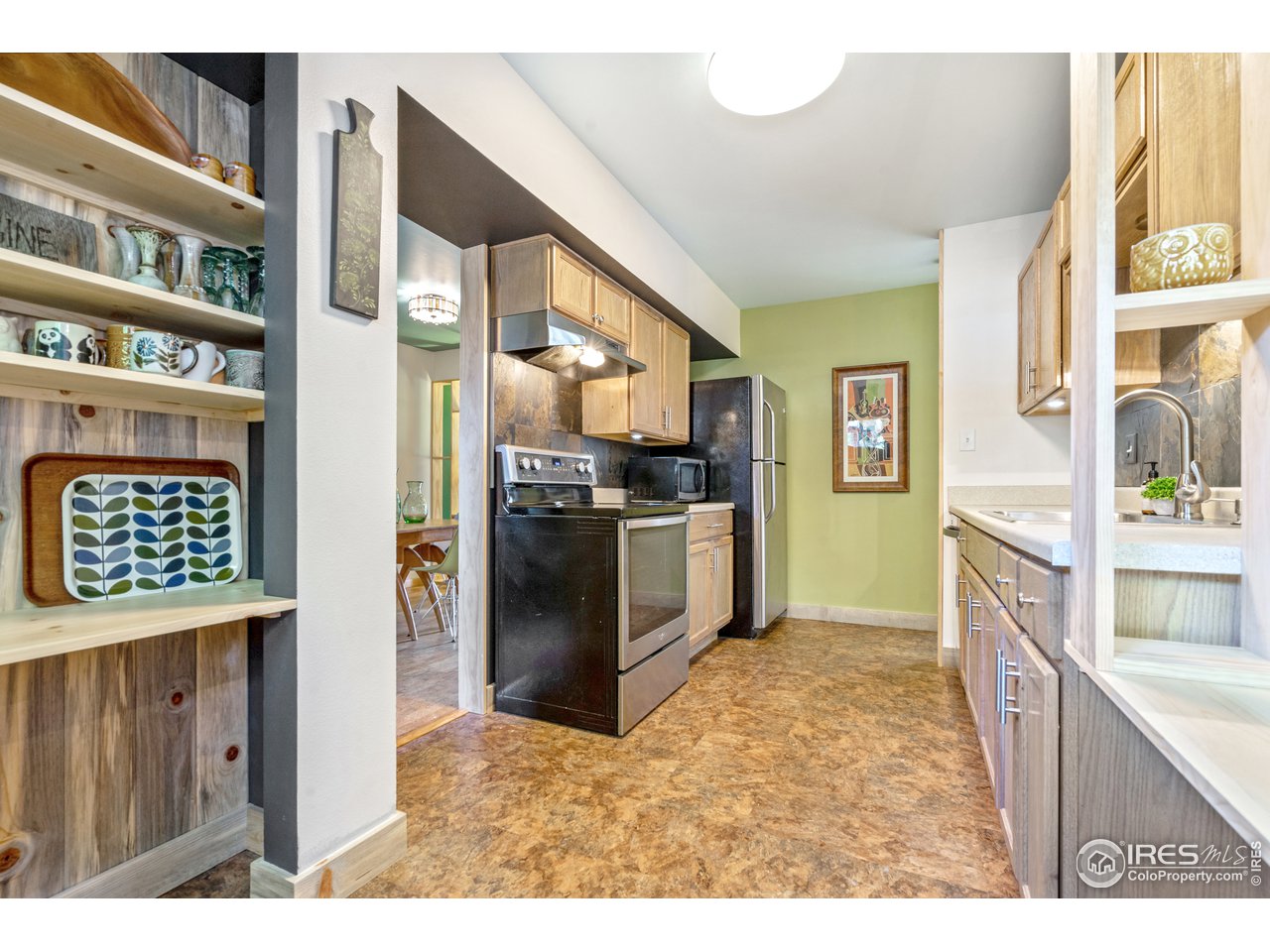 705 East Drake Road, Unit 39 Fort Collins, CO 80525 - Photo 3 of 23 a kitchen view with stainless steel appliances kitchen island granite countertop a refrigerator and a stove top oven