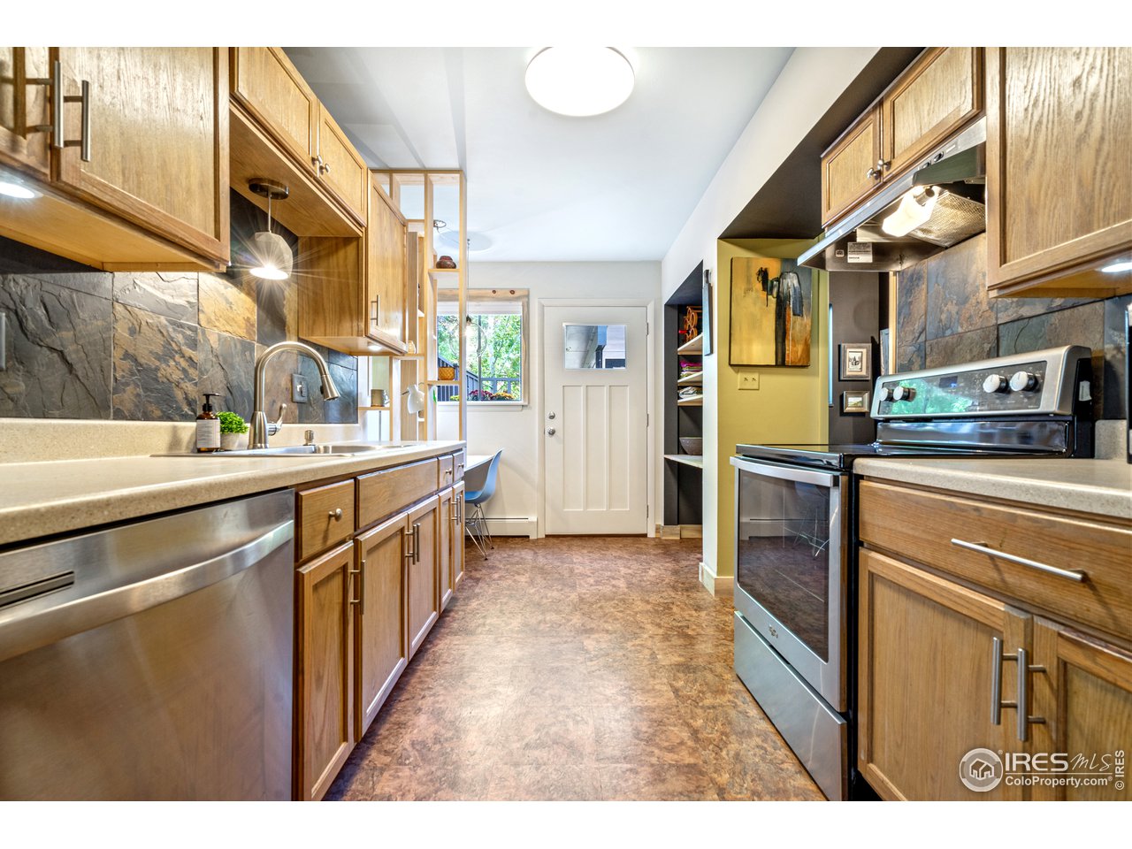 705 East Drake Road, Unit 39 Fort Collins, CO 80525 - Photo 4 of 23 a kitchen with stainless steel appliances a sink and a refrigerator