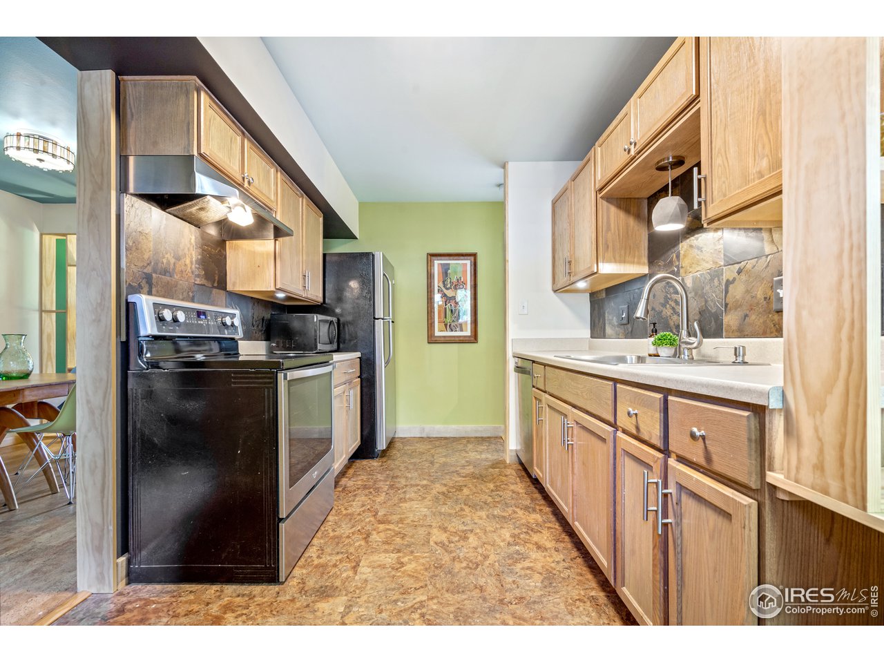 705 East Drake Road, Unit 39 Fort Collins, CO 80525 - Photo 5 of 23 a kitchen with stainless steel appliances kitchen island granite countertop a stove a sink and a refrigerator