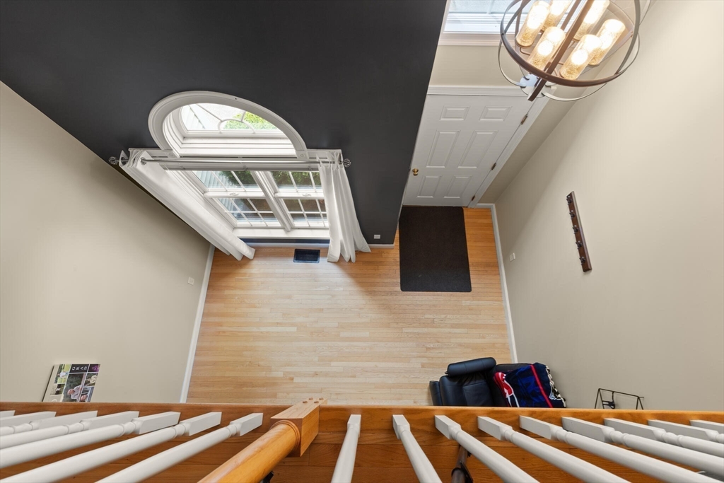 3 Knowlton Circle, Unit 3 Upton, MA 01568 - Photo 13 of 42 a view of spacious bedroom with a bed and a chandelier